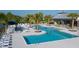 Inviting community pool with lounge chairs, palm trees, and comfortable seating areas to enjoy the Florida lifestyle at 11885 Richmond Trl, Parrish, FL 34219