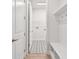 Hallway with bench seating, leading to laundry room with decorative tile flooring at 11885 Richmond Trl, Parrish, FL 34219