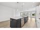 Spacious kitchen island featuring a stainless steel dishwasher and seating for casual dining at 11885 Richmond Trl, Parrish, FL 34219