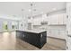 Spacious open kitchen with a center island, white cabinetry, and modern pendant lighting at 11885 Richmond Trl, Parrish, FL 34219