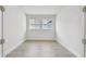 Minimalist room with natural light streaming through twin windows at 11885 Richmond Trl, Parrish, FL 34219