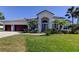 Stunning single-story home with a well-manicured lawn, tropical landscaping, and a two-car garage at 12110 Marblehead Dr, Tampa, FL 33626