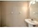 Neutral half bathroom with a pedestal sink and vanity mirror at 1309 Costa Mesa Dr, Wesley Chapel, FL 33543