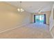 Spacious living room featuring sliding glass doors and abundant natural light at 1309 Costa Mesa Dr, Wesley Chapel, FL 33543