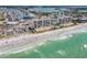 Stunning aerial view of beachfront condos, white sand beach, and turquoise ocean waters at 15000 Gulf Blvd # 704, Madeira Beach, FL 33708