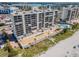 Condominium complex aerial view showcasing multiple balconies, nearby marina, and waterfront location at 15000 Gulf Blvd # 704, Madeira Beach, FL 33708