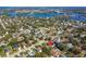 Aerial view of property highlighting its prime location within a lush, green neighborhood with mature trees and manicured lawns at 1514 River Ct, Tarpon Springs, FL 34689