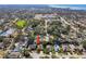 Lovely aerial view of home in a serene, tree-lined neighborhood with access to community tennis and recreational fields at 1514 River Ct, Tarpon Springs, FL 34689