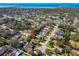 An aerial view of the property with a scenic coastal setting, showcasing lush landscaping in the surrounding neighborhood at 1514 River Ct, Tarpon Springs, FL 34689