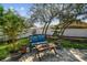 Relaxing backyard seating area with comfortable cushions and a view of the lush landscaping at 1514 River Ct, Tarpon Springs, FL 34689