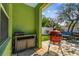 Outdoor kitchen area with a built-in grill and ample counter space overlooking the backyard at 1514 River Ct, Tarpon Springs, FL 34689