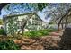 Exterior shot of a well-maintained green backyard area with patio seating at 1514 River Ct, Tarpon Springs, FL 34689