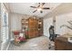 Inviting bedroom features a ceiling fan, neutral paint, and a decorative stained glass window at 1514 River Ct, Tarpon Springs, FL 34689