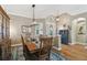 Well-lit dining area featuring hardwood floors, a decorative rug, and a stylish table at 1514 River Ct, Tarpon Springs, FL 34689