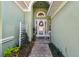 Inviting front porch featuring a decorative wreath on the front door and a charming bench at 1514 River Ct, Tarpon Springs, FL 34689