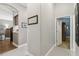 Bright hallway featuring neutral paint, tile floors, white trim, and an arched entryway to a living area at 1514 River Ct, Tarpon Springs, FL 34689