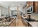 Modern kitchen featuring stainless steel appliances, granite countertops, and tile backsplash at 1514 River Ct, Tarpon Springs, FL 34689