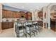 Kitchen showcasing a center island with seating, granite countertops and beautiful cabinetry at 1514 River Ct, Tarpon Springs, FL 34689