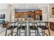 Open kitchen featuring an island with granite countertop and barstool seating at 1514 River Ct, Tarpon Springs, FL 34689