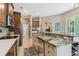 Open kitchen features granite counters, stainless steel appliances, and tile flooring at 1514 River Ct, Tarpon Springs, FL 34689