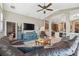 Spacious living room with an open floor plan, modern furniture, large TV, and views into the kitchen at 1514 River Ct, Tarpon Springs, FL 34689