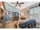 Comfortable living room with a ceiling fan, TV, neutral walls, and a cozy couch with decorative blankets at 1514 River Ct, Tarpon Springs, FL 34689