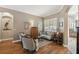 Cozy living room featuring wood floors, shuttered windows, and comfortable seating at 1514 River Ct, Tarpon Springs, FL 34689