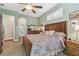 Bedroom featuring a large bed with paisley bedding and wooden furniture, offering a cozy and inviting ambiance at 1514 River Ct, Tarpon Springs, FL 34689