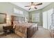 Spacious bedroom with a ceiling fan, multiple windows, and stylish furnishings offering natural light and comfort at 1514 River Ct, Tarpon Springs, FL 34689