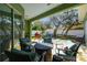 Charming covered patio area with ample seating, brick pavers, and an outdoor kitchen at 1514 River Ct, Tarpon Springs, FL 34689