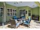 Cozy outdoor patio boasts comfortable seating, tile pavers, and a built-in grill at 1514 River Ct, Tarpon Springs, FL 34689