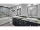 Modern bathroom featuring dual sinks, stone counters, and a luxurious soaking tub with stone accents at 175 2Nd S St # P03, St Petersburg, FL 33701