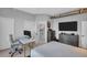 Bedroom featuring a desk, walk-in shower, tv and storage at 175 2Nd S St # P03, St Petersburg, FL 33701