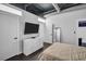 Bright bedroom featuring a light color palette, TV, and ample storage space with easy access to other rooms at 175 2Nd S St # P03, St Petersburg, FL 33701