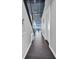 Hallway with tiled floors, neutral walls, and partial views of the waterfront from the connecting living space at 175 2Nd S St # P03, St Petersburg, FL 33701