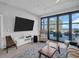 Bright living room with a tv and sliding glass doors to balcony overlooking ocean view at 175 2Nd S St # P03, St Petersburg, FL 33701