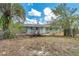 View of backyard with the house that needs a little TLC at 18855 Dvorak Dr, Spring Hill, FL 34610