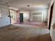 Open-concept living room featuring unfinished floors and walls, and an exterior entry gate at 1905 10Th W St, Palmetto, FL 34221