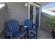 Relaxing balcony featuring a pair of Adirondack chairs and sliding glass doors at 19915 Gulf Blvd # 704, Indian Shores, FL 33785