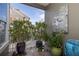Cozy balcony adorned with lush plants and a tranquil, decorative Buddha statue at 19915 Gulf Blvd # 704, Indian Shores, FL 33785