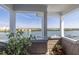 Beautiful waterfront views from a covered balcony with potted plants and decorative accents at 19915 Gulf Blvd # 704, Indian Shores, FL 33785