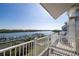 Balcony view overlooking a scenic waterway and marina, perfect for enjoying tranquil waterfront living at 19915 Gulf Blvd # 704, Indian Shores, FL 33785