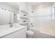 Stylish bathroom featuring a sleek vanity, decorative shelving, and a glass-enclosed shower/tub combo at 19915 Gulf Blvd # 704, Indian Shores, FL 33785