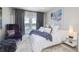 Inviting bedroom featuring cozy furniture, stylish decor, and sliding doors that open onto a waterfront balcony at 19915 Gulf Blvd # 704, Indian Shores, FL 33785