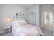 Cozy bedroom with pink accents, themed décor, and a glimpse of a hallway with staircase at 19915 Gulf Blvd # 704, Indian Shores, FL 33785