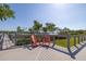 Relaxing deck area with comfortable seating overlooking the water and lush greenery at 19915 Gulf Blvd # 704, Indian Shores, FL 33785