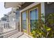 Exterior view of a home's balcony with charming doors framed by lush greenery, enhancing curb appeal at 19915 Gulf Blvd # 704, Indian Shores, FL 33785