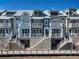 Charming multi-level townhouses featuring individual balconies and elevated entrances with staircases at 19915 Gulf Blvd # 704, Indian Shores, FL 33785