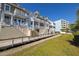 Beautiful building exterior features multiple levels with charming balconies and lovely landscaping at 19915 Gulf Blvd # 704, Indian Shores, FL 33785