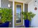 Charming front door entrance with potted plants and a welcoming ambiance at 19915 Gulf Blvd # 704, Indian Shores, FL 33785